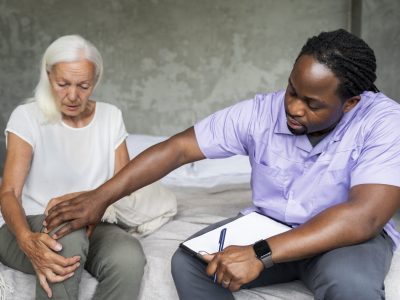 male social worker taking care old woman1 scaled
